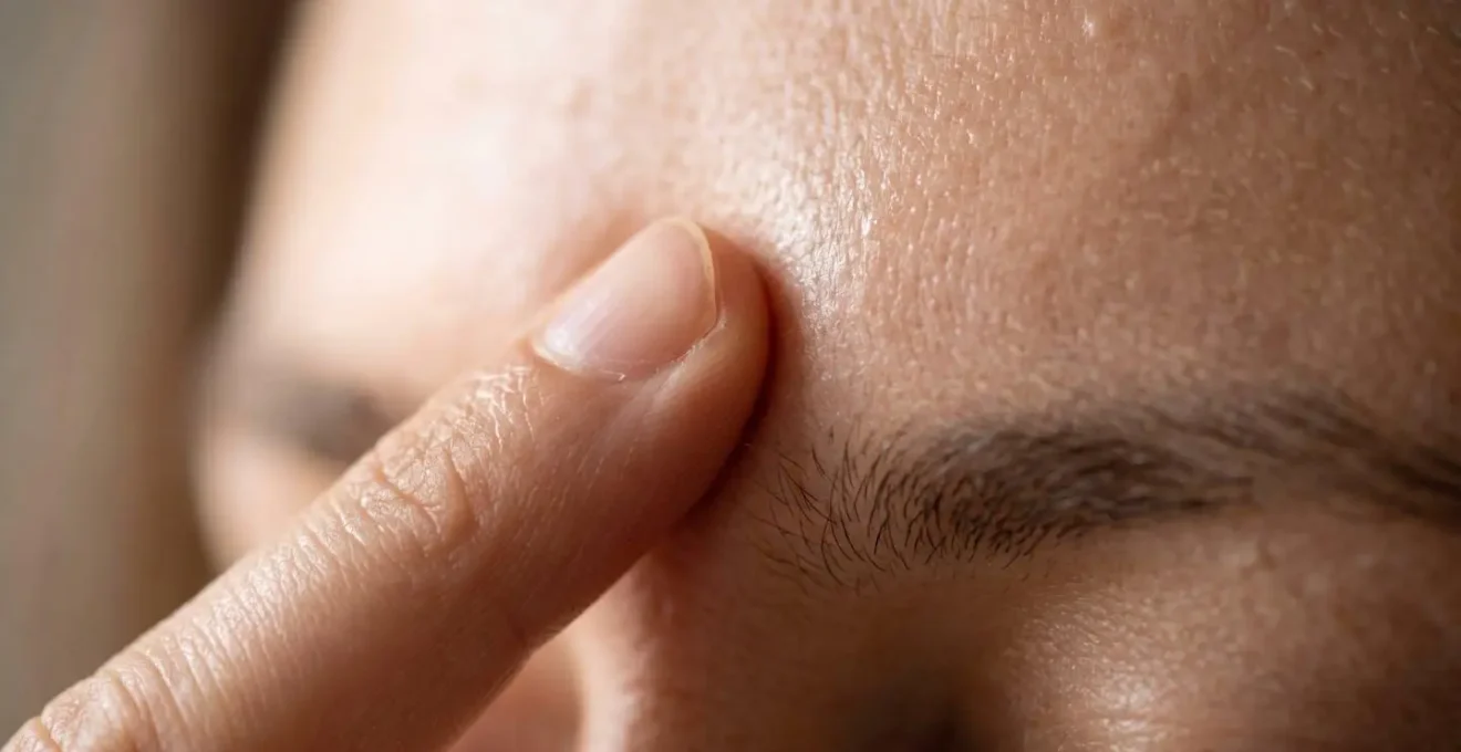 Gros plan sur des mains effectuant la technique de tapping EFT sur les points du visage